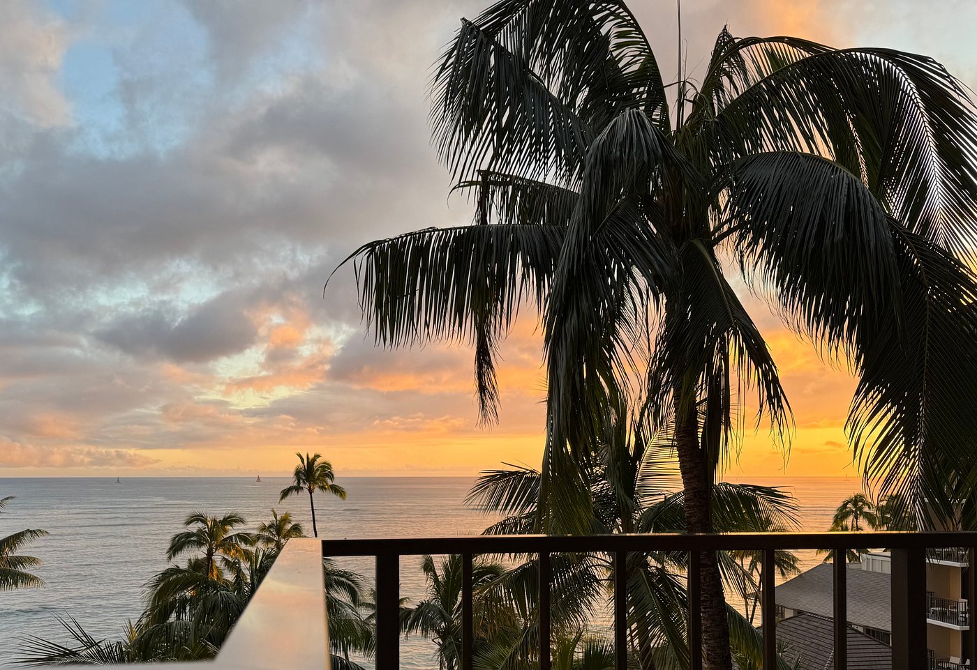Sunset and palm trees seen from a room at Halekulani
